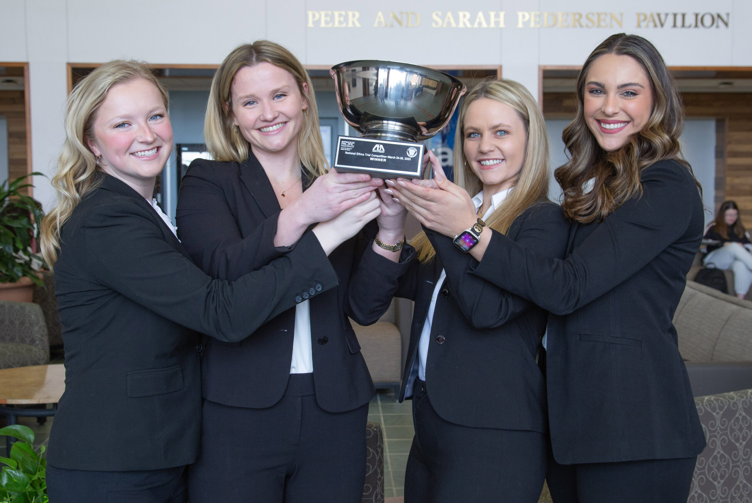 Trial Team with trophy from 15th National Ethics Trial Competition: Allison Heil, Madelyn Foster, Eliza Powers, and Mariana Renke