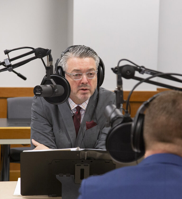 Professor Brubaker speaks during a live podcast recording at the College of Law