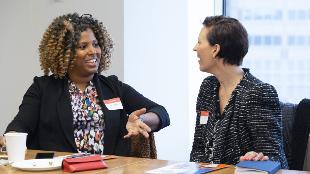 Two female alumnae converse at a Women Lead event