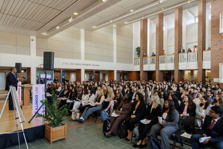 The incoming class listens intently during Dean Jamelle Sharpe's remarks at Orientation