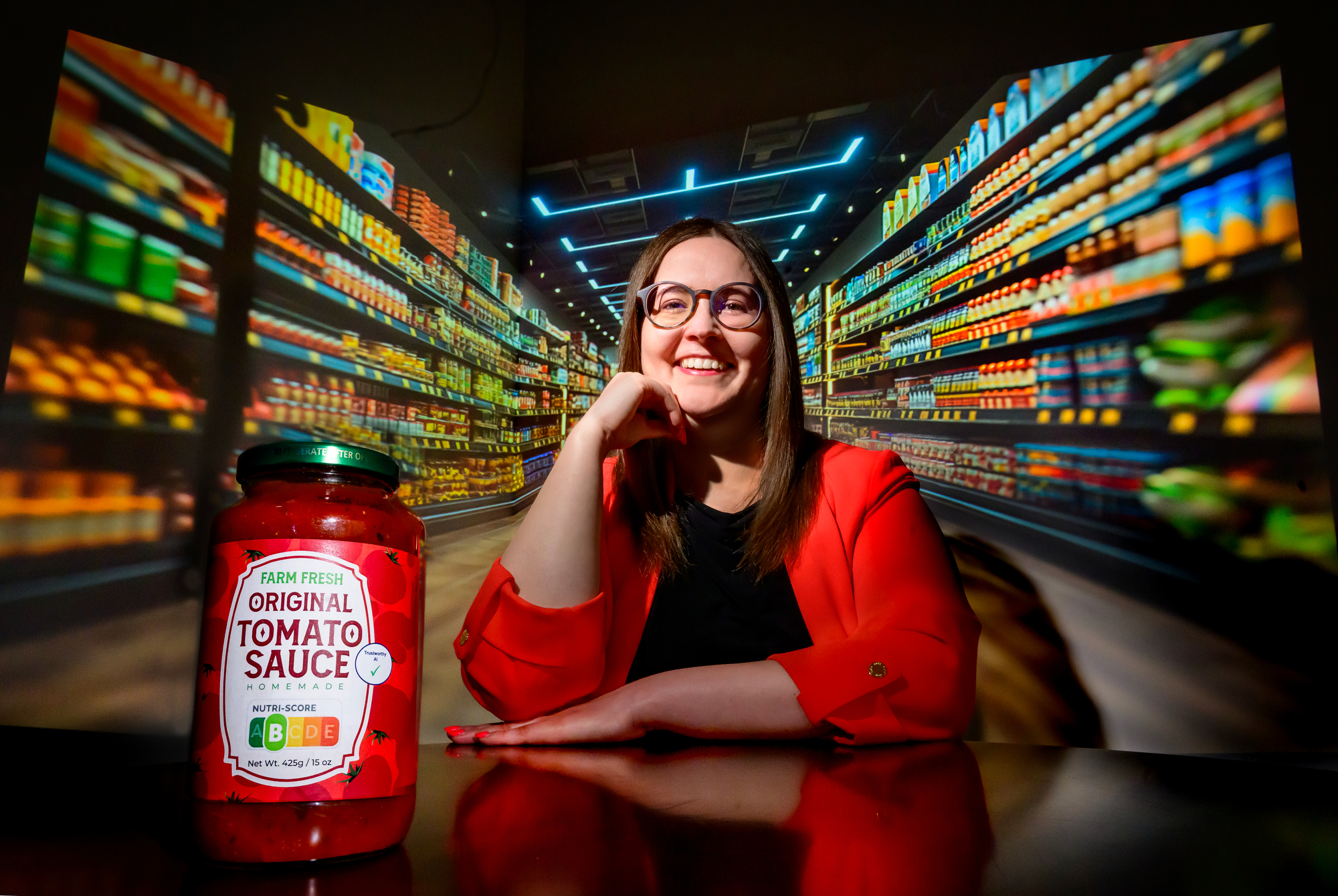 Law Professor Sara Gerke newest work discusses the benefits of the FDA developing afront-of-package nutrition labeling system that would help AI powered medical devices used by consumers to create better health outcomes. A mock-up label on this tomato sauce jar includes a Nutri-Score food grade a “Trustworthy AI” indicator. Photo taken at the University of Illinois Urbana-Champaign on Monday, March 31, 2025. (Photo by Fred Zwicky / University of Illinois Urbana-Champaign)