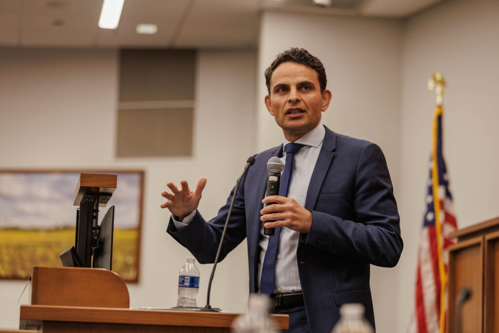 A male speaker presents during the AI in Cancer Surgery and Care Conference