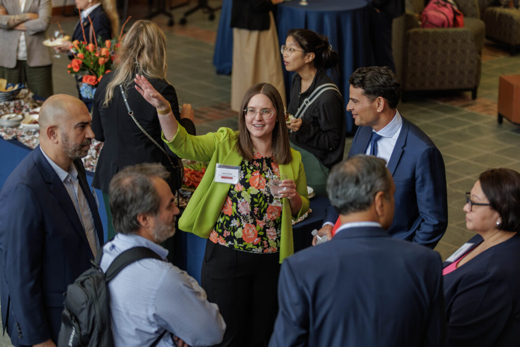 Professor Sara Gerke and other panelists enjoy a reception during the AI in Cancer Surgery and Care Conference