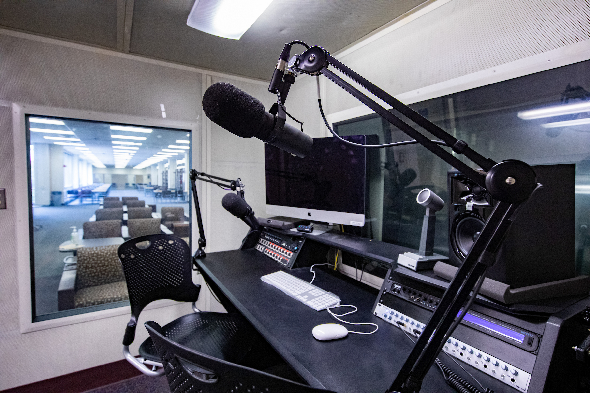 An audio recording studio with microphone and chair