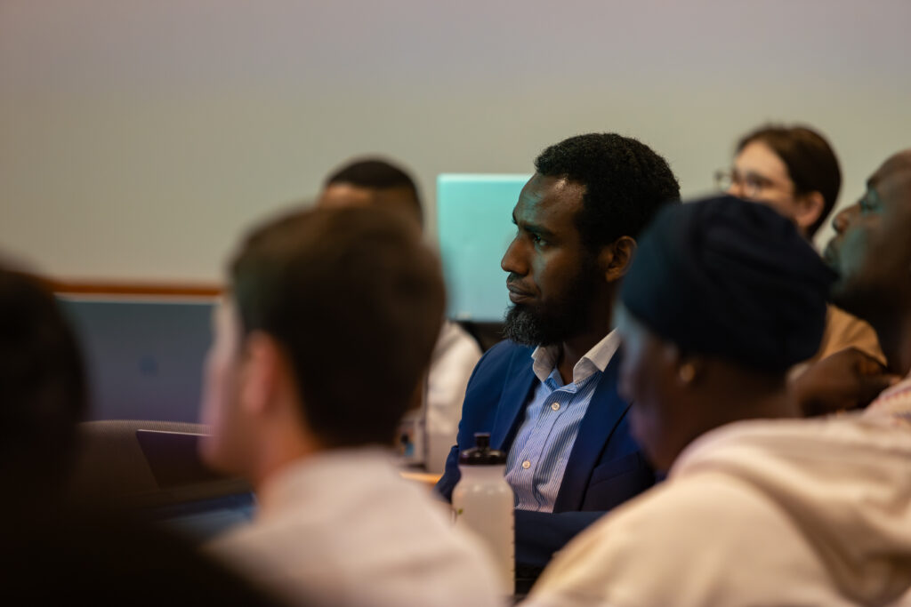 Students listen to a lecture being given by a professor during class.