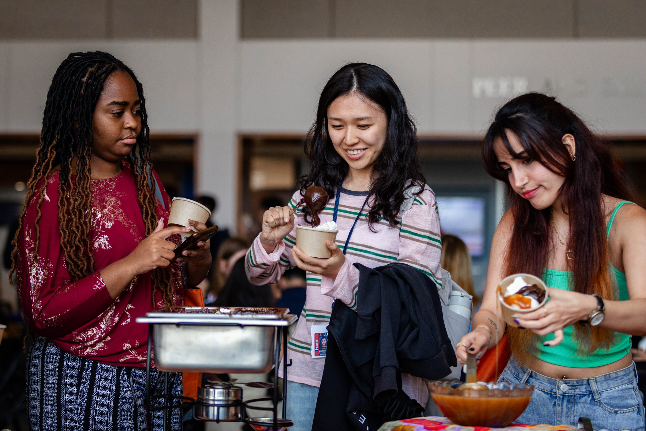Female students enjoy an ice cream social during international student orientation