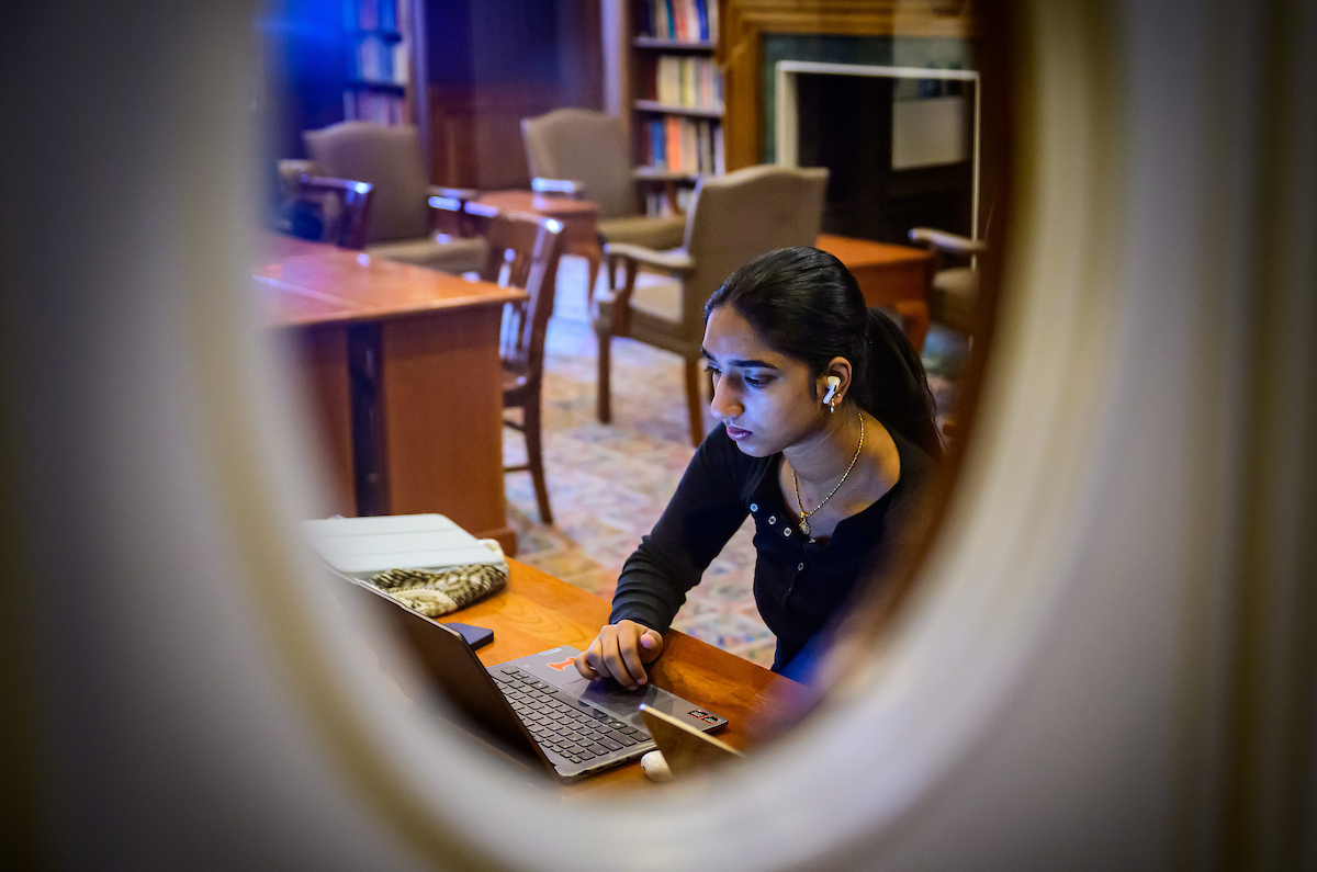 Female student studies on laptop